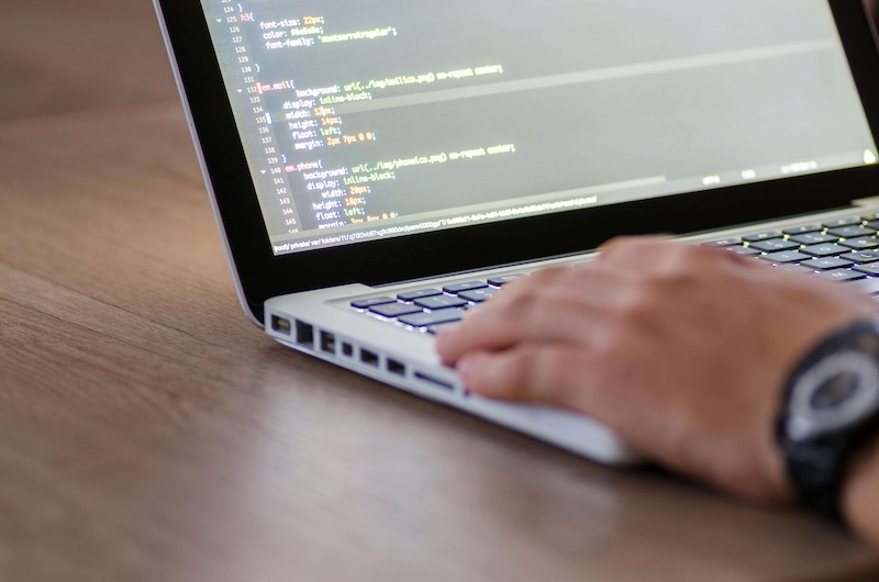 Developer coding on laptop